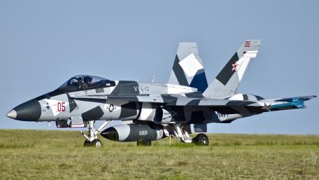 Sleek Military Jet in Camouflage Design wallpaper