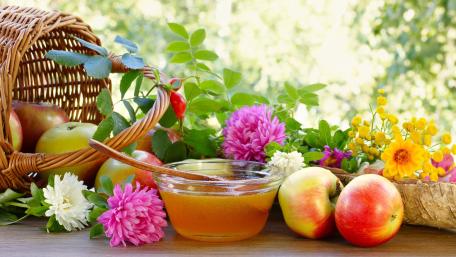 Fresh Apples and Vibrant Flowers Displayed Artistically wallpaper