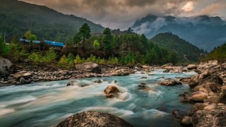 Serene River Under Cloudy Skies wallpaper