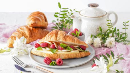 Delicious Morning Delight Featuring Croissant and Raspberries wallpaper