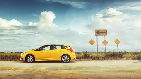 Vibrant Yellow Car on an Open Road wallpaper