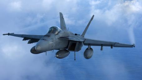 Fighter Jet in Action Above the Clouds wallpaper