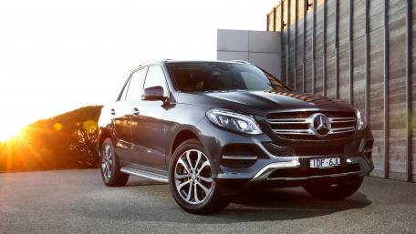 Sleek Mercedes SUV Against a Stunning Sunset Background wallpaper