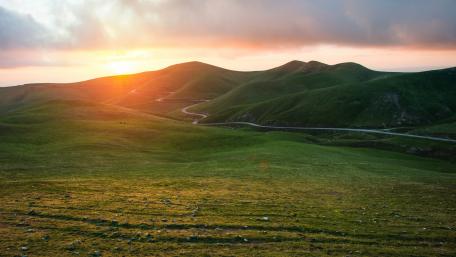 Breathtaking Sunset Over Rolling Hills wallpaper