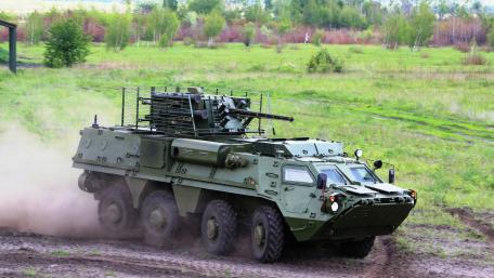 Military Vehicle in Action on Rugged Terrain wallpaper
