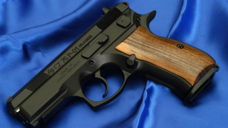 CZ 75 Pistol on Blue Fabric Background wallpaper