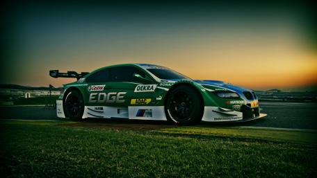 Dynamic Touring Car Under Sunset Glow wallpaper