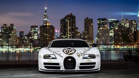 Luxury Bugatti Veyron Stands Out Against City Skyline wallpaper