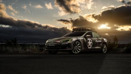 Sleek Tesla Model S in a Stunning Sunset Scene wallpaper