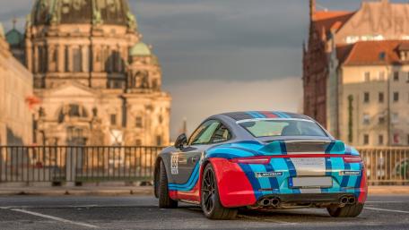 Vibrant Porsche Supercar by Historic Architecture wallpaper