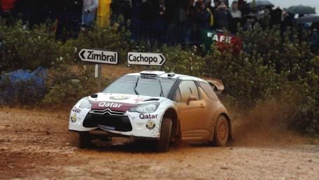 Rally Car in Action on Muddy Track wallpaper