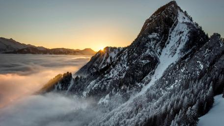 Majestic Winter Sunrise Over Snowy Peaks wallpaper