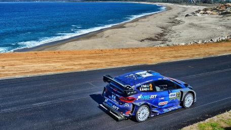 Fast Racing Car on Coastal Road Scene in Stunning 4K Resolution wallpaper