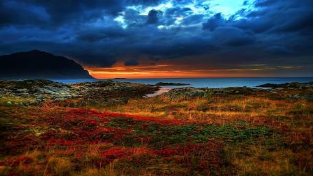 Serene Sunset Over Rocky Coastline wallpaper