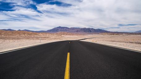 Endless Road Through Serene Desert Landscape wallpaper