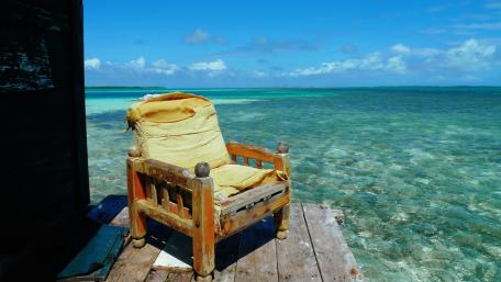 Old chair over the ocean wallpaper