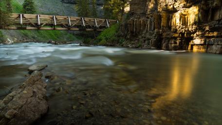 Serene Bridge Over Tranquil River in Nature Scenery wallpaper