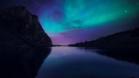 Mystical Aurora Borealis Over Tranquil Lake wallpaper