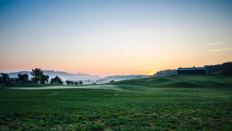 Serene Sunrise Over Rolling Green Fields wallpaper