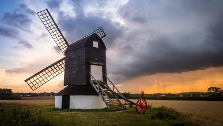 Windmill at Dusk with Dramatic Clouds wallpaper