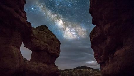 Majestic Milky Way Over Rock Formations wallpaper