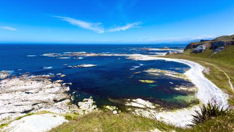 Serene Coastal Beauty Under a Blue Sky wallpaper