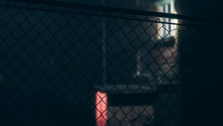 Urban Shadow Behind a Fence at Night wallpaper