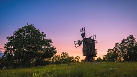 Serene Windmill in a Picturesque Meadow wallpaper
