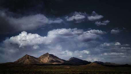 Majestic Mountain Range Under Dramatic Clouds wallpaper