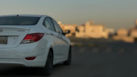 Sleek White Car on Urban Road wallpaper