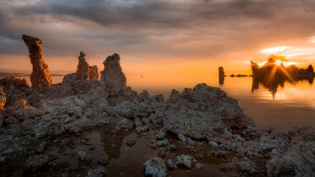 Majestic Rock Formation at Dawn Over Still Waters wallpaper