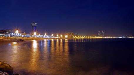 Shimmering Night Lights Along the Shoreline wallpaper