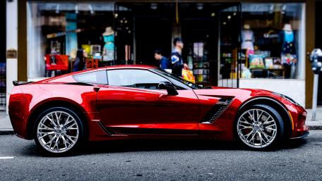 Sleek Red Supercar in Urban Setting wallpaper