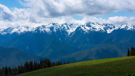 Majestic Mountain Range Under Cloudy Skies wallpaper