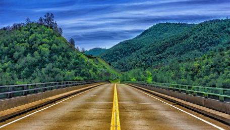 Endless Highway Through Verdant Hills wallpaper