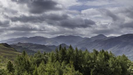 Majestic Mountain Landscape Under Cloudy Skies wallpaper
