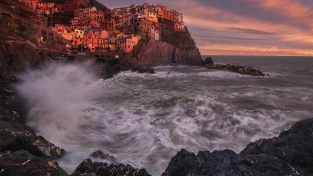 Vibrant Coastal Village Under Sunset Sky wallpaper