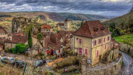 Charming Village Nestled Among Scenic Mountains wallpaper