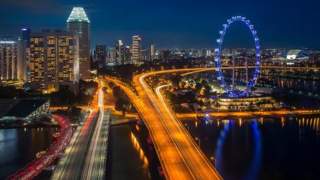 Vibrant Cityscape at Night with Illuminated Landmarks wallpaper