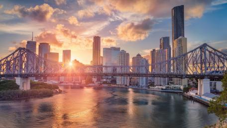 Stunning Sunrise Over Urban Skyline and Bridge wallpaper