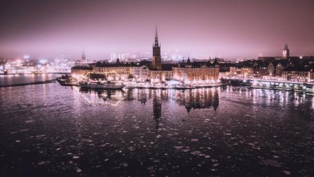 Mystical City Lights Reflecting on Water at Dusk wallpaper
