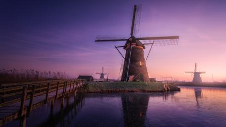 Serene Windmills at Dawn in Tranquil Landscape wallpaper