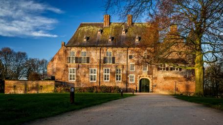 Historic Brick Building in Vibrant Park Setting wallpaper
