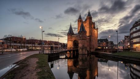Historic City Fortress Reflected in Calm Waters wallpaper