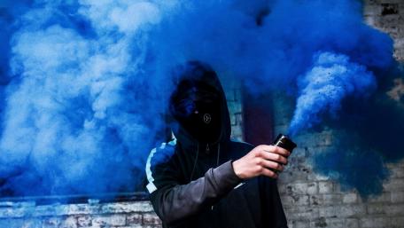 Masked Figure Surrounded by Blue Smoke wallpaper