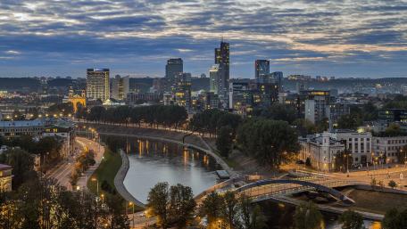 Cityscape at Dusk with Serene River View wallpaper