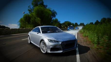 Sleek Audi TT Speeds Down Scenic Roadway wallpaper