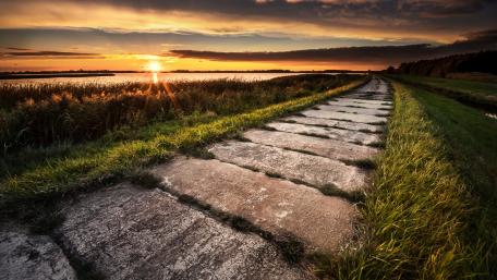 Serene Sunset Over Tranquil Pathway wallpaper