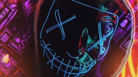 Neon Masked Joker in Cyberpunk Cityscape wallpaper