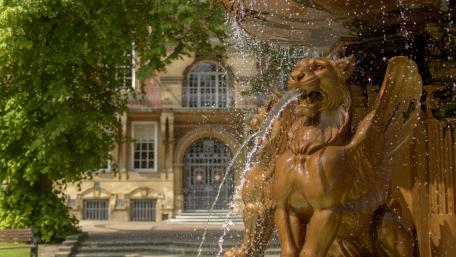 Majestic Fountain with Lion Sculpture wallpaper
